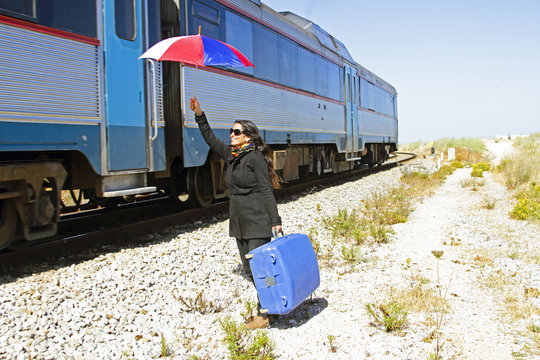 Woman traveler at a passing train