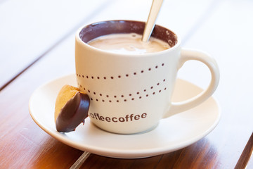 Heart shaped cookie and fresh cappuccino
