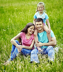 Fototapeta premium Family on green grass.