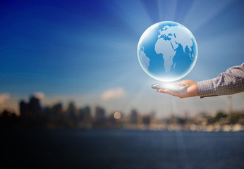 Touch screen mobile phone, in hand and globes