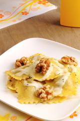Ravioli with cheese sauce and walnuts