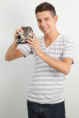 Young man using an old camera