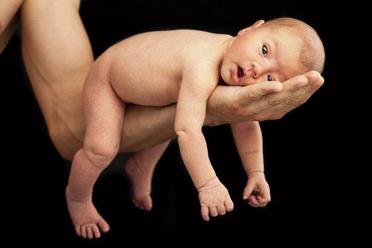 Newborn Boy Lying On His Dad's Arm