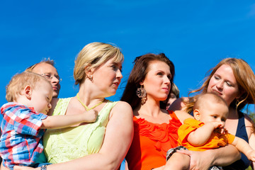 Family and multi-generation - fun on meadow in summer