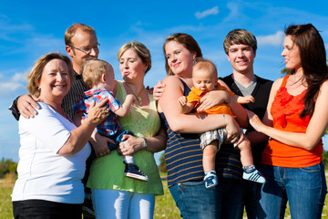 Family and multi-generation - fun on meadow in summer
