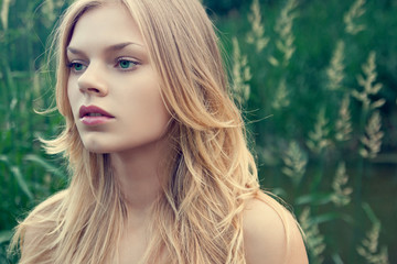 Portrait of beautiful young girl outdoors in summer