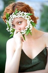 Portrait of a beautiful redhaired curly female model