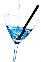 detail of blue cocktail with bubbles and black straw