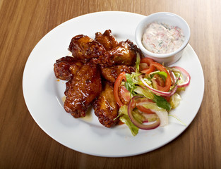 Roasted chicken wings on plate