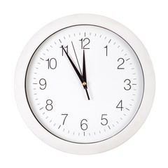 Clock face showing five minutes to twelve