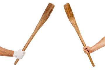 Two hands holding bats