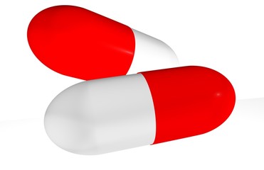 Two red pills isolated on white background