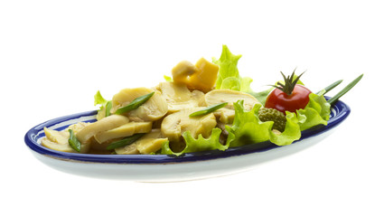 Marinated mushrooms in white saucer isolated on white