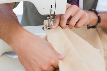 Obraz na płótnie Canvas Close up of man sewing