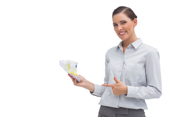 Happy businesswoman showing money in her hand