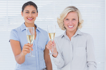 Attractive businesswomen drinking champagne