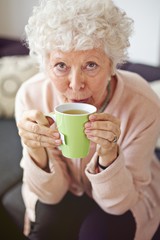Mature Lady at Home Drinking Tea