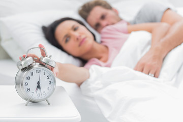 Woman turning off the alarm clock