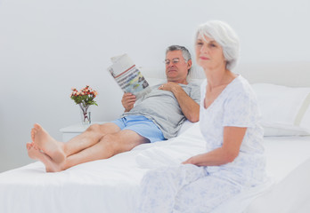 Obraz na płótnie Canvas Mature woman sitting on bed