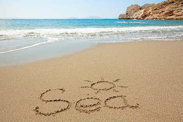 Inscription on wet sand