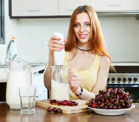 cheerful housewife cooking with cherry