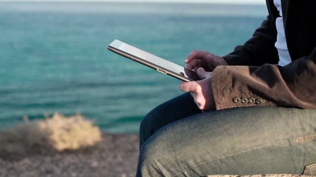 Man hands working with tablet computer near vantage point