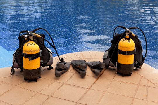 Aqualung And Flippers Near The Pool