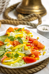 Closeup of healthy salad with salmon and vegetables
