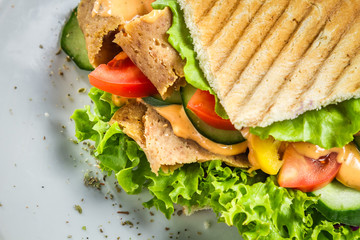 Closeup of kebab on a bun with vegetables and meat