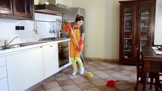 happy housewife cleaning and dancing