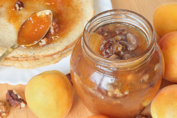 A pot of apricot jam with walnuts