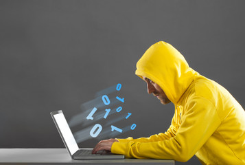 man in a yellow jacket working on the Internet