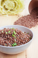 Buckwheat in a bowl on the wooden table