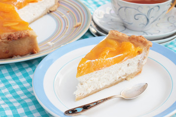 Piece of tasty peach cheesecake with agar jelly on a plate with