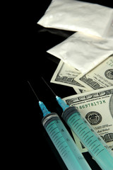 Drugs, money and  syringes, isolated on black