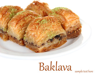 Sweet baklava on plate isolated on white