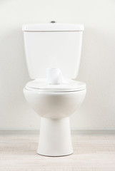 White toilet bowl with toilet paper in a bathroom