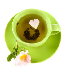 Cup of herbal tea with hip rose flower, isolated on white