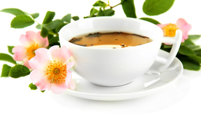 Cup of herbal tea with hip rose flowers, isolated on white