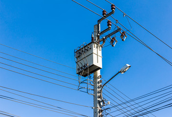 electricity high voltage transformer against blue sky