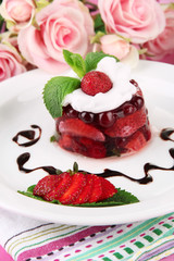 Tasty jelly dessert with fresh berries, on pink roses