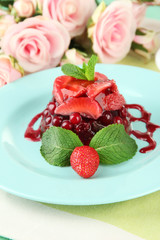 Tasty jelly dessert with fresh berries, on bright background