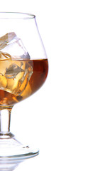 Brandy glass with ice isolated on white