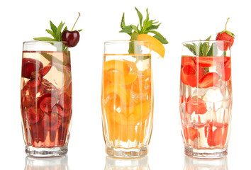 Glasses of fruit drinks with ice cubes isolated on white