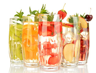 Glasses of fruit drinks with ice cubes isolated on white