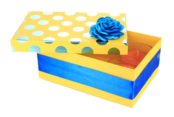 Yellow gift box with candles isolated on white