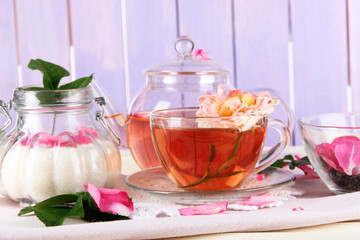 Kettle and cup of tea from tea rose