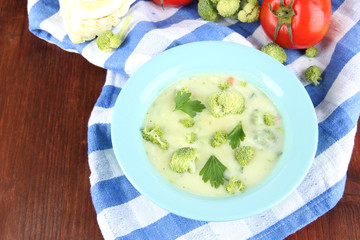 Cabbage soup in plates on napkin on wooden table