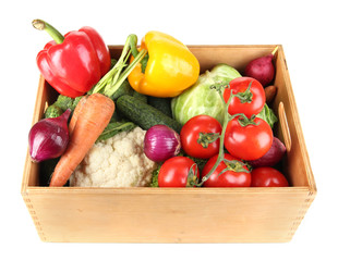 Fresh vegetables in wooden box on white background