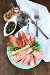 Bacon on plate on napkin on board on window table